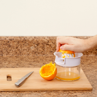 teaching a child how to juice orange