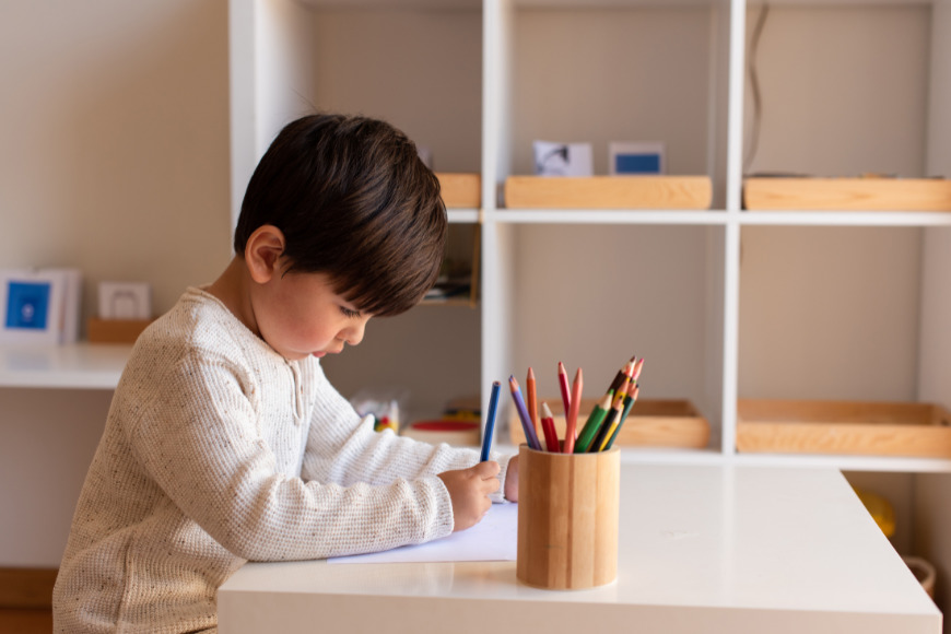 a child practicing cursive writing in a Montessori school